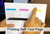 A person using a printer to print a self test for troubleshooting.