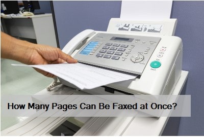 Fax machine feeding multiple pages of paper for sending.
