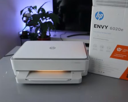 HP ENVY 6052e printer with Wi-Fi setup instructions for easy connection.